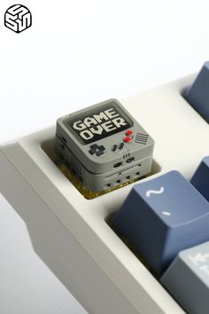 a game over key board sitting on top of a keyboard