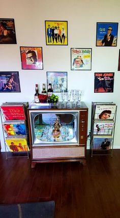 an old fashioned ice cream vending machine in a room with posters on the wall