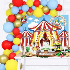 a circus themed birthday party with colorful balloons and desserts in front of the tent