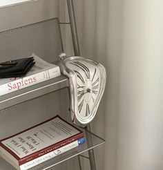 a stack of books sitting on top of a metal shelf