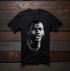 Micheal Jordan Graphic Tee t-shirt, Micheal Jordan gold chain t-shirt, Micheal Jordan gold teeth t-shirt, Gold teeth, gold chain mj graphic T-shirt.  The unisex soft-style t-shirt puts a new spin on casual comfort. Made from very soft materials, this tee is 100% cotton for solid colors. Heather colors and sports grey include polyester. The shoulders have twill tape for improved durability. There are no side seams. The collar is made with ribbed knitting to prevent curling damage.  .: Made with 1 Jordan Tshirt Nike, Michael Jordan Shirt Design, Jordan Gold, Kids Jordan Shirt, Jordan Tees, Metallica Tee, Gold Teeth, Michael Jordan, Twill Tape