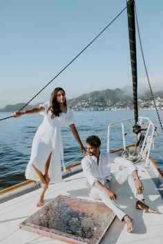 a man and woman posing on the deck of a boat