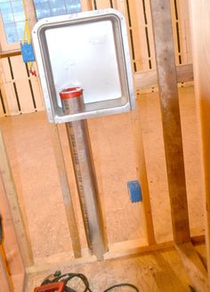 the inside of a house being built with wood framing and electrical equipment on the floor