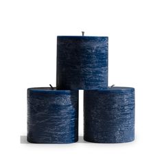 three blue candles sitting on top of each other