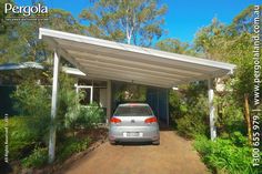 a car parked in front of a house with a carport attached to the roof