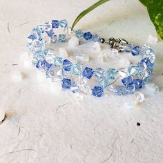 I struggled with a way to use up the random beads in between ordering supplies. Odd number for earrings, but not enough to make a full bracelet in that one color. What I came up with is a cuff bracelet fit for a frozen princess. Handmade Blue Crystal Beaded Bracelets, Handmade Blue Crystal Bracelet, Frozen Princess, Icy Blue, Holiday Colors, Braided Bracelets, Not Enough, Birthstone Jewelry, One Color