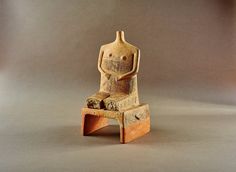 a small wooden statue sitting on top of a table