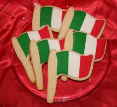 cookies decorated with the flag of italy on a red plate