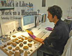 a man sitting in front of a desk with rocks on it