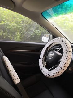 the interior of a car with a steering wheel cover