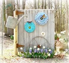 a garden shed with flowers and a watering can