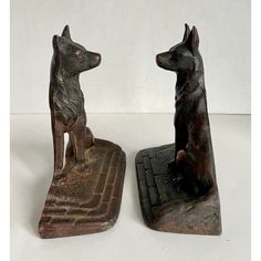 two small dog figurines sitting next to each other