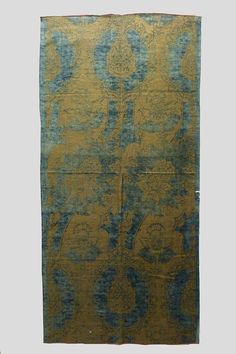 an old rug with blue and yellow designs on it