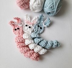 three crocheted animals sitting next to each other on top of a white surface