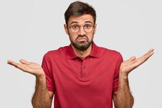 a man in a red shirt is holding his hands out to the side while wearing glasses