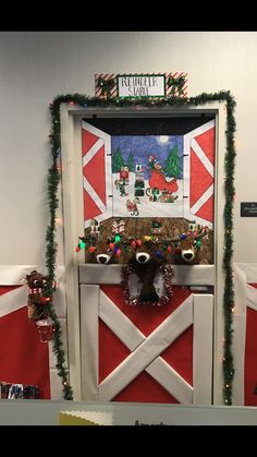 a door decorated with christmas decorations and lights in the shape of a barnyard scene