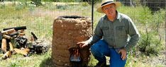 a man kneeling down next to a fire pit