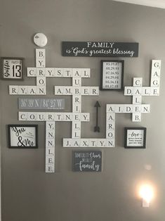 a cross made out of scrabble tiles on the wall