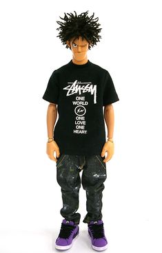 a doll wearing a black t - shirt and jeans