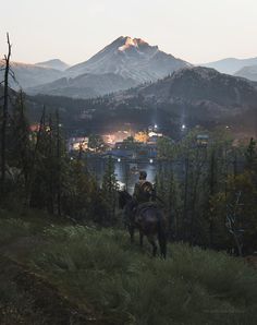 a man riding on the back of a brown horse next to a lush green forest