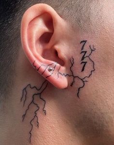 a man's ear has a lightning tattoo on it