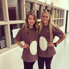 two girls in reindeer costumes standing next to each other