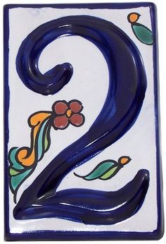 a blue and white ceramic number two with flowers