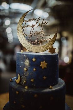 a blue cake with gold stars and a moon on top that says from my life to yours