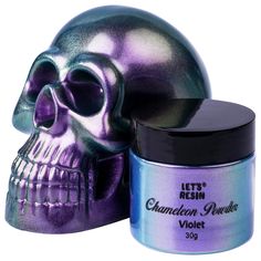 a purple and silver skull next to a jar