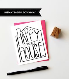 a happy new house card next to a rubber stamp