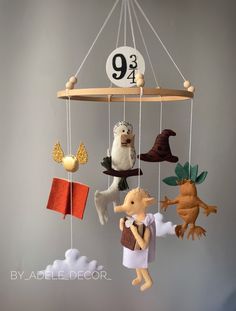 a mobile with animals hanging from it's sides and the number nine on top