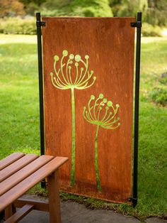 a wooden sign with flowers painted on it