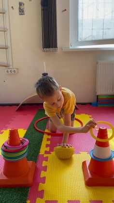 a little boy playing with toys in a room