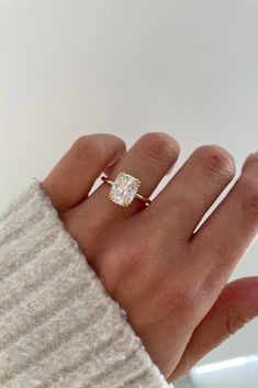 a woman's hand with a ring on it