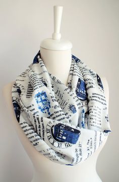 a white mannequin head wearing a scarf with blue and black words on it