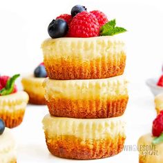 a stack of mini cheesecakes with berries on top