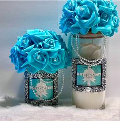 two vases with blue flowers in them