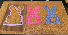 a door mat with bunny and rabbit cut outs on it