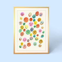 an art print with different types of donuts on it in gold frame against a blue background