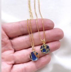 Dainty Sapphire Coin Medallion Pendant Necklace Add a new twist to the classic Sapphire Necklace with these stunners! Features Sapphire Gemstones that are circle cut and framed in gold electroplating. Each medallion pendant is similar, yet unique - making these one of kind. Stones are double sided. *Pendant size is approximately 12mm {Stones will be randomly selected and crafted into your one of a kind necklace. No two pendants are exactly alike} Hangs on your choice of chain: 14k Gold Plated Li Blue Round Pendant Necklace For Her, Blue Round Pendant Necklace As Gift For Her, Personalized Blue Necklace For Her, Personalized Blue Necklace As A Gift For Her, Personalized Blue Necklace Gift For Her, Blue Round Pendant Jewelry For Her, Blue Round Pendant Jewelry Gift For Her, Blue Personalized Round Pendant Jewelry, Blue Personalized Round Pendant Necklace