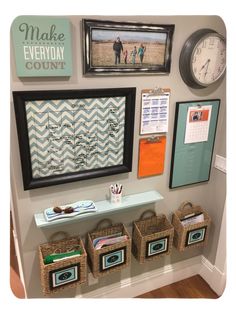 a wall with pictures and other items on it, including framed pictures above the shelf