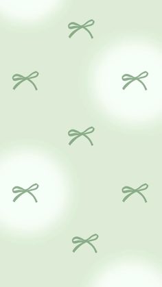 a green wallpaper with small bows on it