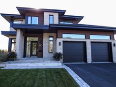 a large house with two garages on each side