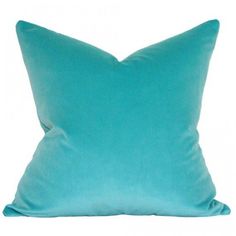 a blue pillow sitting on top of a white wall