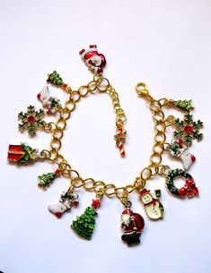 a gold bracelet with christmas charms on it