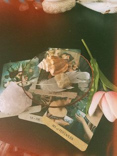 a table topped with cards and flowers on top of it