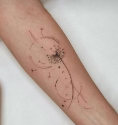 a dandelion tattoo on the left arm