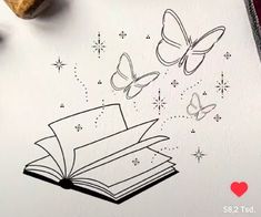 an open book with butterflies flying out of it