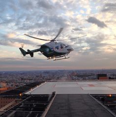 a helicopter is flying low over the city