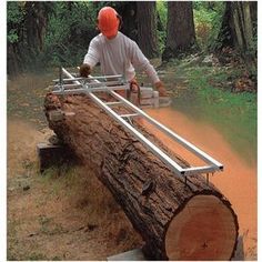 a man in an orange helmet is working on a log